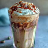 Creamy iced vanilla bean frappuccino with toasted coconut foam, perfect for a refreshing summer treat.