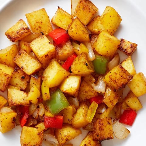 Hearty, diner-style home fries, bursting with savory onions and bell peppers.