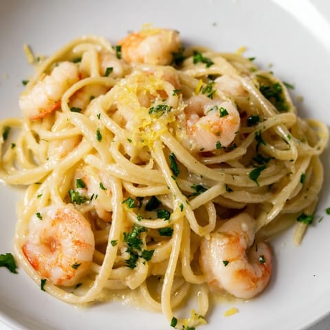 Fork twisting through tender pasta and shrimp in a bright, lemony garlic butter sauce.  
