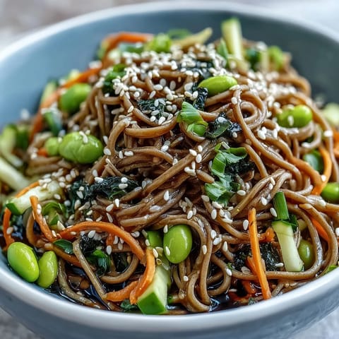 Cool soba noodles and crisp cucumber slices are topped with edamame in a savory sesame dressing.  