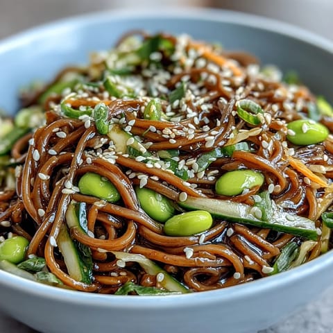 A vibrant Soba Noodle Bowl with carrots, scallions, and toasted sesame seeds for texture.  